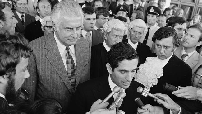 Sir John Kerr’s secretary, David Smith, announces the Dismissal as Gough Whitlam looks on. Picture: AAP