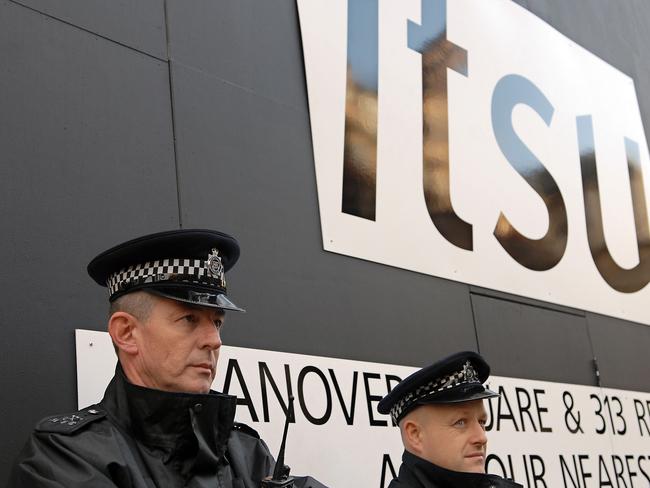 Police stand guard outside the sushi chain where traces of polonium 210 were found. It was later revealed that the Russian suspects attempted to poison Litvinenko at the site weeks earlier.