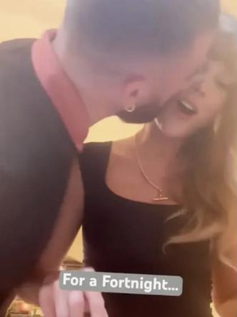 The NFL star kisses the singer in a cute video.