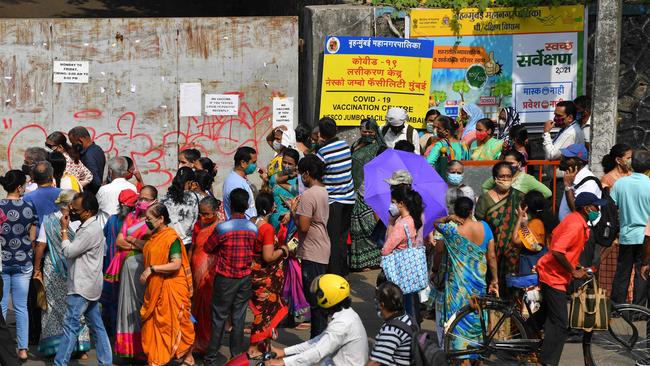 People gather outside coronavirus vaccination centre in Mumbai. Picture: AFP.