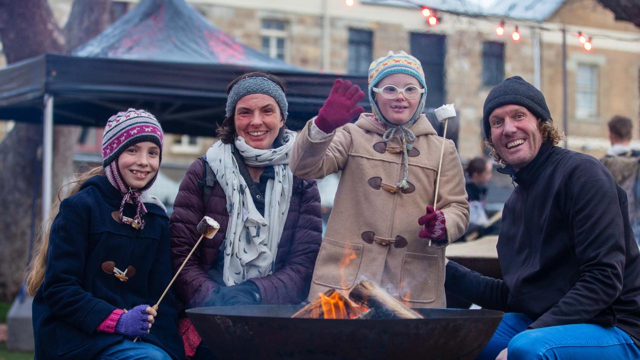 Hobart Family Dani and Mark Hinder with daughters Grace and Amelie, 10, toasting marshmallows at the City of Hobart Winter Feast sensory session. Picture: Linda Higginson