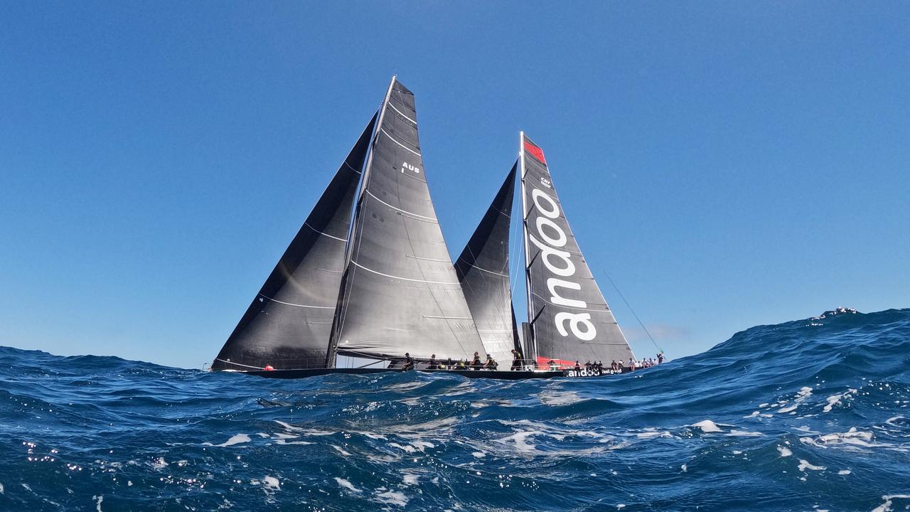 Moneypenny and Andoo Comanche sail out of the heads during the 2022 Sydney to Hobart. Photo by Mark Evans/Getty Images