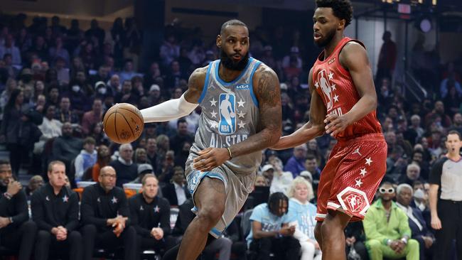 CLEVELAND, OHIO - FEBRUARY 20: LeBron James #6 of Team LeBron dribbles the ball around Andrew Wiggins #22 of Team Durant in the first half during the 2022 NBA All-Star Game at Rocket Mortgage Fieldhouse on February 20, 2022 in Cleveland, Ohio. NOTE TO USER: User expressly acknowledges and agrees that, by downloading and or using this photograph, User is consenting to the terms and conditions of the Getty Images License Agreement.   Tim Nwachukwu/Getty Images/AFP == FOR NEWSPAPERS, INTERNET, TELCOS & TELEVISION USE ONLY ==