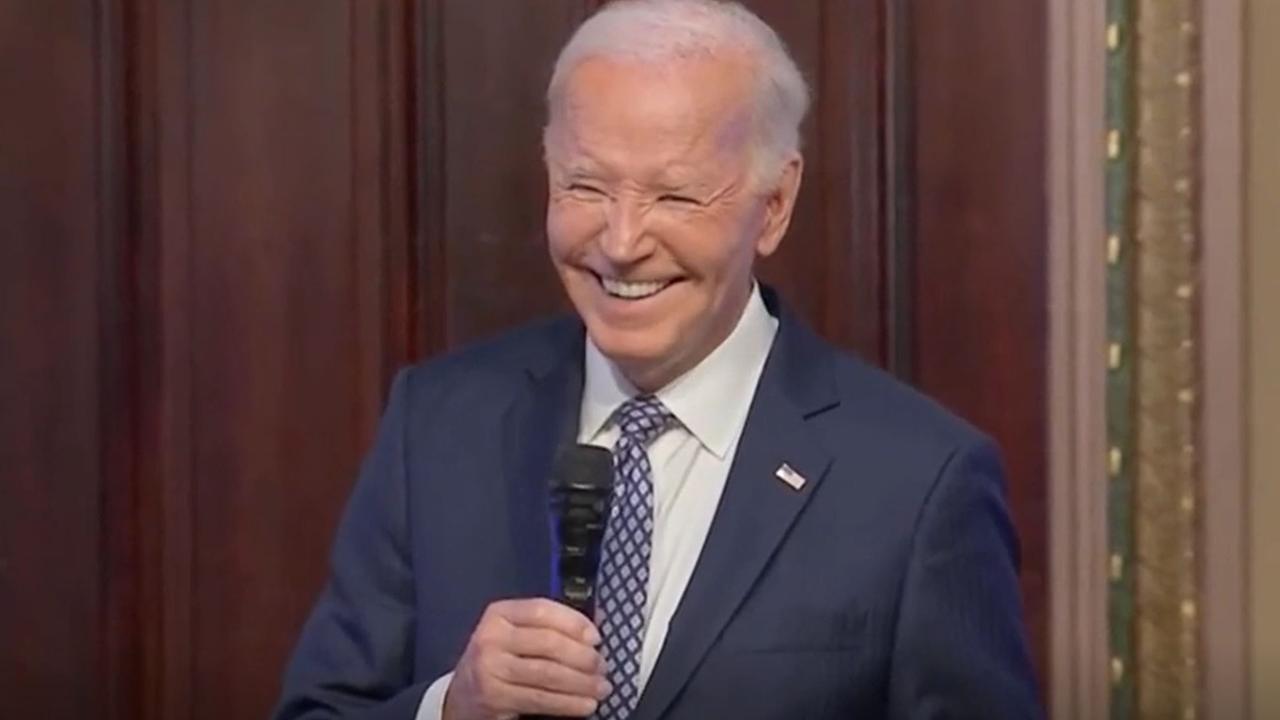 Joe Biden laughs with influencers at the White House.