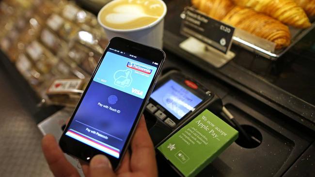 A customer uses the Apple Pay system in London. Apple Pay and Google Pay wallets illustrate some of the new and complex issues that are arising. Picture: Chris Ratcliffe