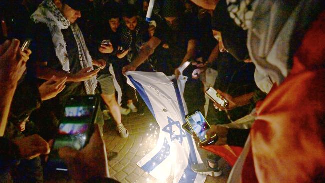 SYDNEY, AUSTRALIA - NewsWire Photos OCTOBER 9, 2023: ÃRally For A Free PalestineÃ protest burn the Israeli flag on the forecourt of The Sydney Opera House in Sydney following the recent outbreak of war between Israel and Palestine. Picture: NCA NewsWire / Jeremy Piper