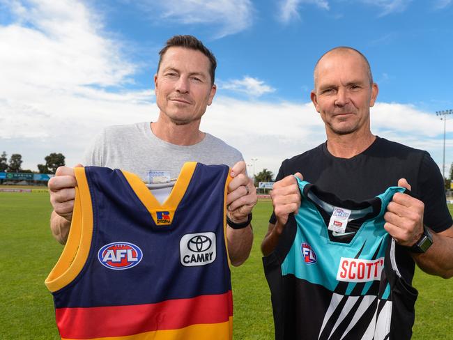 Adelaide's 1997 captain Mark Bickley and Port Adelaide's inaugural AFL vice-captain Brayden Lyle together with their old guernseys. Picture: Brenton Edwards