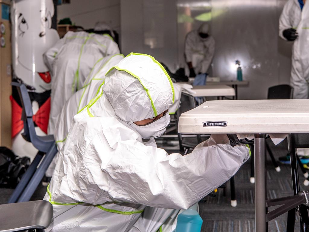 AAP Canterbury-Bankstown Express Cleaners photographed cleaning a classroom at St Christopher's Catholic Primary on Monday, 16 March 2020. Coronavirus fears, St Christopher's Catholic Primary. (AAP Image / Monique Harmer)