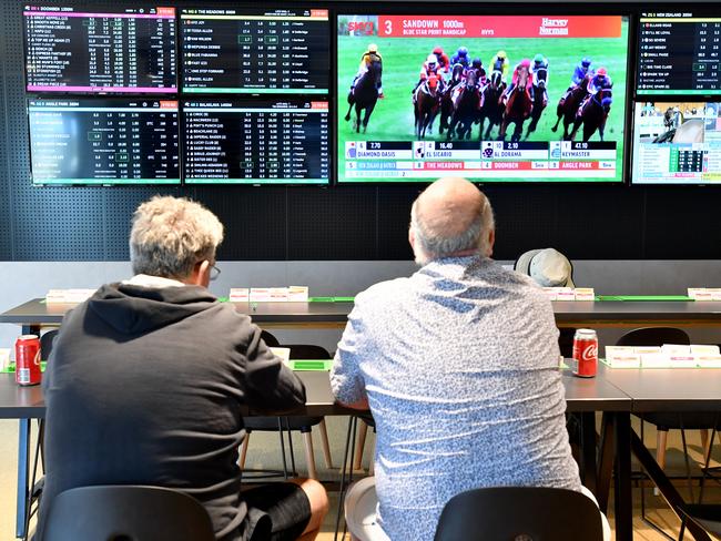 Customer's are seen inside a Tabcorp venue in Brisbane, Wednesday, August 14, 2019. Tabcorp Holdings, which operates in the gambling and media industry announced a net profit after tax (NPAT) result for the full year of $362.5 million and revenue of $5.5 billion from its Lottery, Keno, TAB, and Sky Racing business. (AAP Image/Darren England) NO ARCHIVING