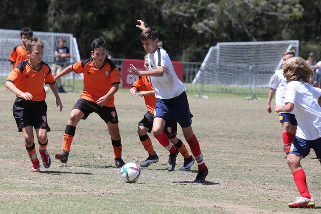 The Premier Invitational football tournament on the Gold Coast. Brisbane Roar Orange v TFC Brisbane White under-13s in action. Picture: Mike Batterham.