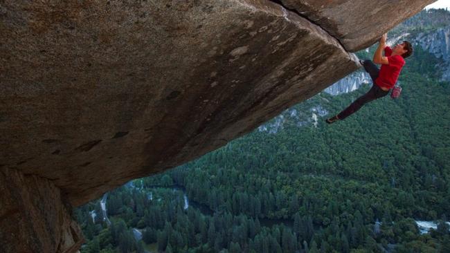 Alex Honnold making a rope-less ascent of the famous Seperate Reality, a difficult overhang perched 500ft. above the ground. This route has only been done rope-less three other times.