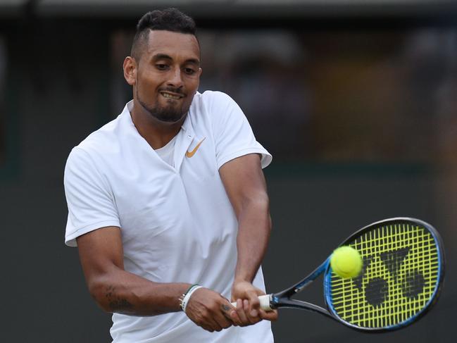 Australia's Nick Kyrgios returns to Japan's Kei Nishikori in their men's singles third round match on the sixth day of the 2018 Wimbledon Championships at The All England Lawn Tennis Club in Wimbledon, southwest London, on July 7, 2018. / AFP PHOTO / Oli SCARFF / RESTRICTED TO EDITORIAL USE