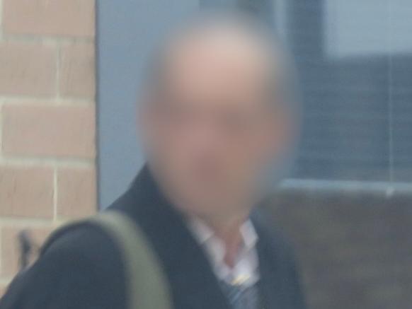 The man, aged in his 30s, leaving Wyong Local Court after pleading guilty to filming his stepdaughter in the shower. Picture: NewsLocal