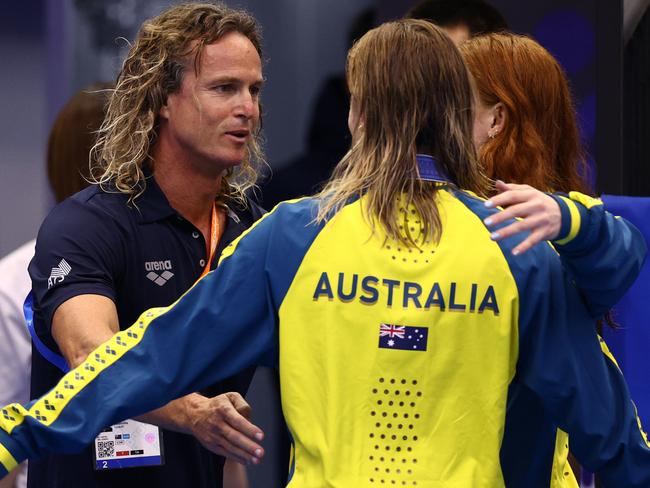 FUKUOKA, JAPAN - JULY 26:  Australian swim coach Dean Boxall hugs gold medallist Mollie O'Callaghan of Team Australia and Ariarne Titmus of Team Australia during the medal ceremony for Women's 200m Freestyle Final on day four of the Fukuoka 2023 World Aquatics Championships at Marine Messe Fukuoka Hall A on July 26, 2023 in Fukuoka, Japan. (Photo by Clive Rose/Getty Images)