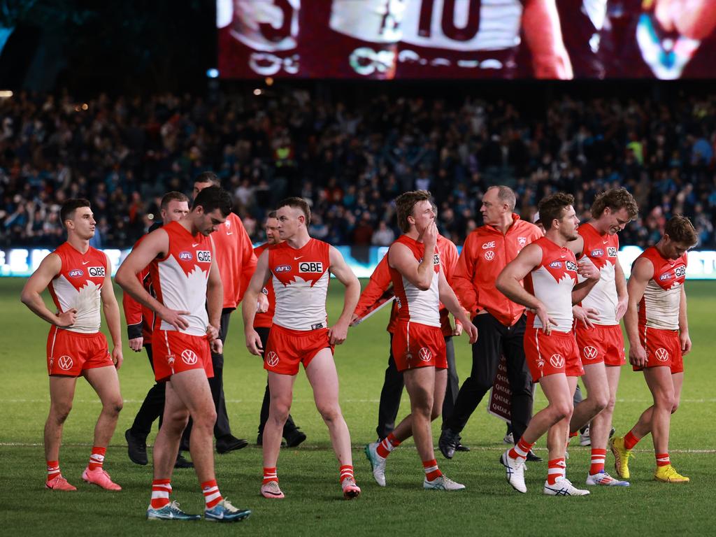 The Swans walk off the field on Saturday night. Picture: James Elsby/AFL Photos via Getty Images.