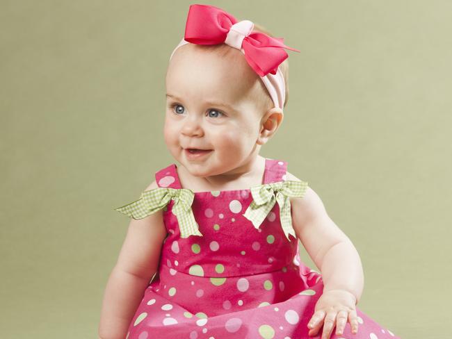 Baby girl in pink sitting , Generic, Picture; Getty Images