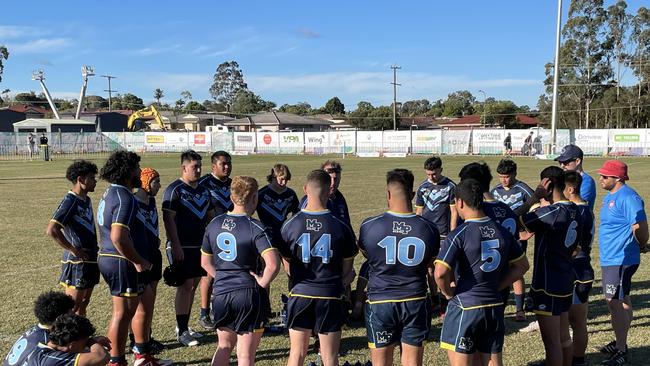 Mabel Park SHS reserves listen to coach Johnston's halftime address.