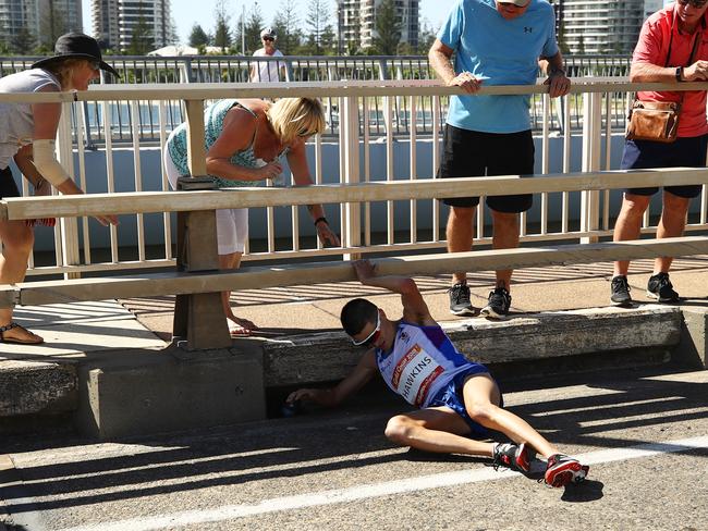 GOLD COAST, AUSTRALIA - APRIL 15:  Callum Hawkins of Scotland collapses as he competes in the Men's marathon on day 11 of the Gold Coast 2018 Commonwealth Games at Southport Broadwater Parklands on April 15, 2018 on the Gold Coast, Australia.  (Photo by Cameron Spencer/Getty Images)