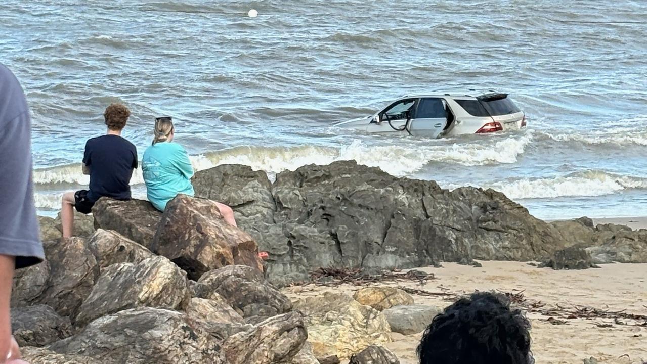 An SUV somehow ended up in the ocean at Yorkeys Knob on Friday afternoon. Picture: Paige Foster