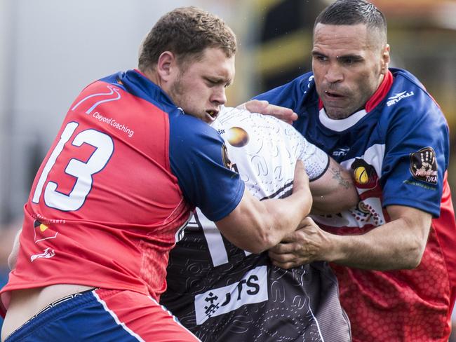 Anthony Mundine helps to wrap up a Redfern All Blacks player. Picture: Jenny Evans