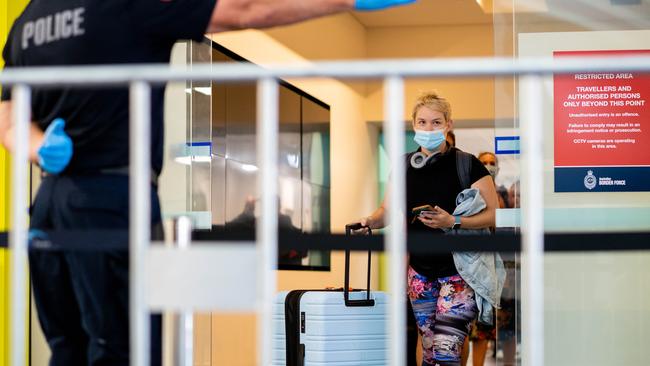 Scenes at Darwin Airport when Greater Brisbane was declared a COVID-19 hot spot by the NT government, with all travellers entering the Territory required to go into mandatory quarantine effective immediately. Two flights were in the air when the announcement was made. Picture: Che Chorley