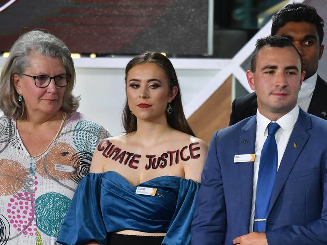 ACT's 2020 Young Australian of the Year finalist Madeline Diamond has painted "CLIMATE JUSTICE" on her upper chest during the 2020 Australian of the Year Awards at the National Arboretum in Canberra. Picture: AAP/Mick Tsikas