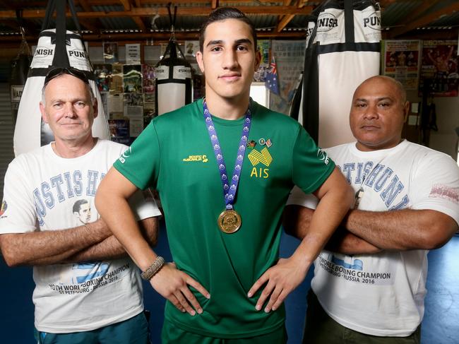 World youth champion Justsis Huni with dad Rocki Huni (right) and trainer Mark Wilson. Picture: Jono Searle.