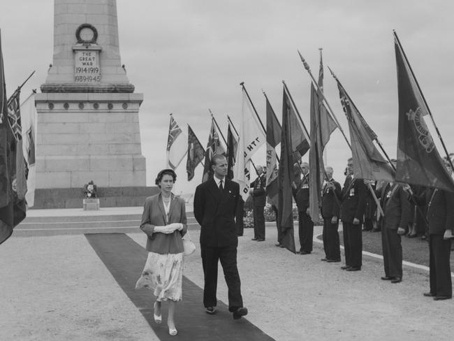 Queen Elizabeth II and Prince Philip walk past the standards of the ex-service men's associations after laying a wreath on the war memorial at Queen's Domain in Hobart, Tasmania on February 21, 1954. Picture: Paul Popper/Popperfoto/Getty Images)