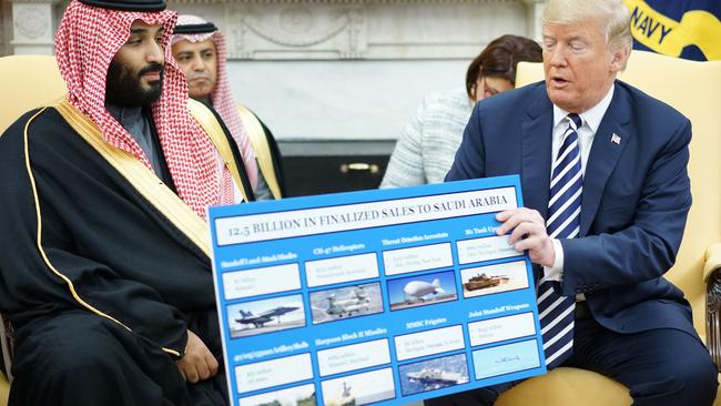 Donald Trump holds a defence sales chart with Saudi Arabia's Crown Prince Mohammed bin Salman in the Oval Office. Picture: AFP.