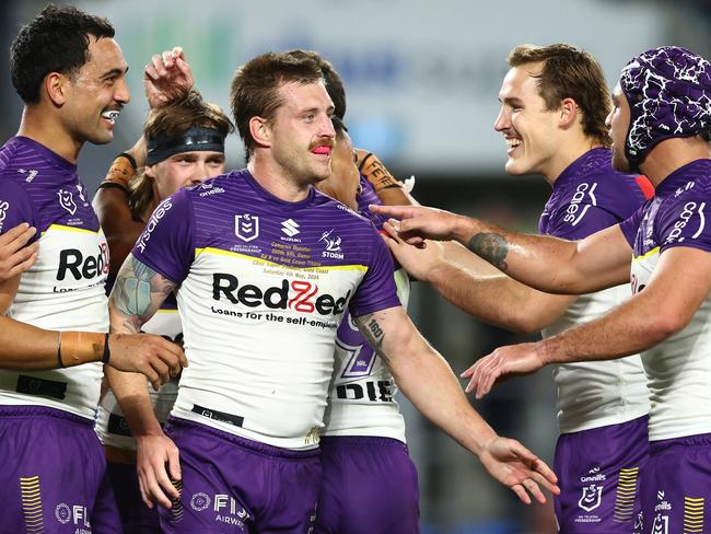 GOLD COAST, AUSTRALIA - MAY 04: Cameron Munster and Storm celebrate a try by team mate Ryan Papenhuyzen of the Storm during the round nine NRL match between Gold Coast Titans and Melbourne Storm at Cbus Super Stadium, on May 04, 2024, in Gold Coast, Australia. (Photo by Chris Hyde/Getty Images)