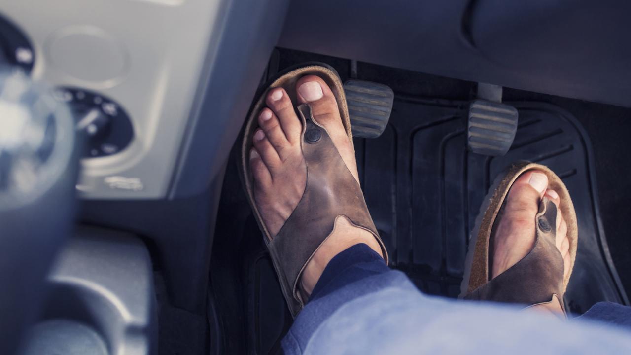 Left foot. Asian barefoot car Driving.