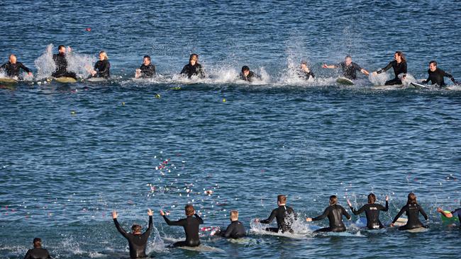 People attending Zach Bray's memorial paddle-out at North Curl Curl Beach. Picture: Adam Yip