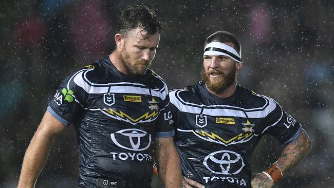 Josh McGuire (right) with Gavin Cooper. McGuire faces a nervous wait to see if he’ll play the Broncos. Picture: Ian Hitchcock/Getty Images