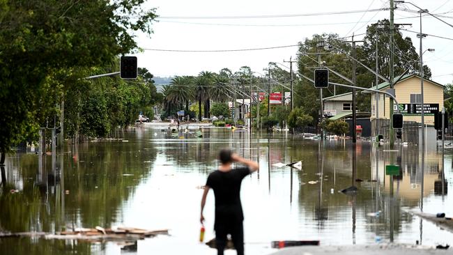 A man looks over a flooded Lismore street on March 31, 2022. Picture: Dan Peled/Getty Images