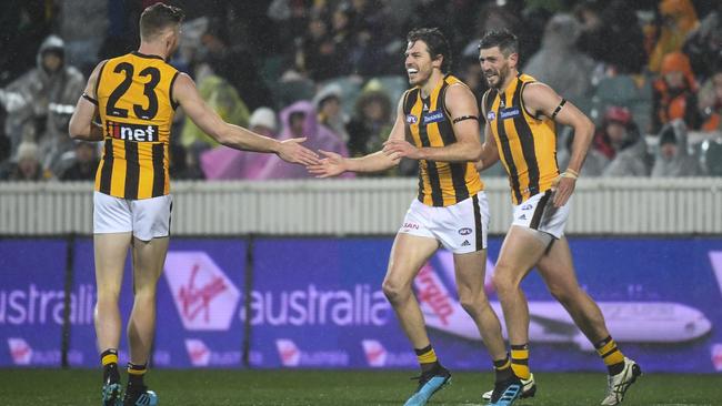 Tim O’Brien, Isaac Smith and Ricky Henderson celebrate a goal. Picture: AAP