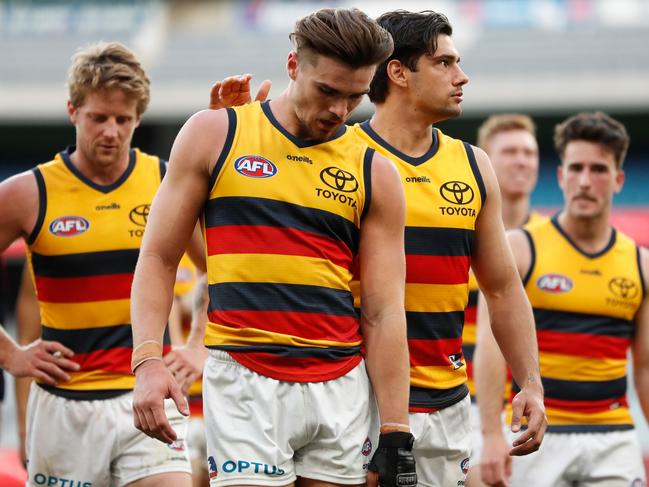 MELBOURNE, AUSTRALIA - AUGUST 15: Ben Keays (L) and Shane McAdam of the Crows react after a loss during the 2021 AFL Round 22 match between the Melbourne Demons and the Adelaide Crows at the Melbourne Cricket Ground on August 15, 2021 in Melbourne, Australia. (Photo by Michael Willson/AFL Photos via Getty Images)