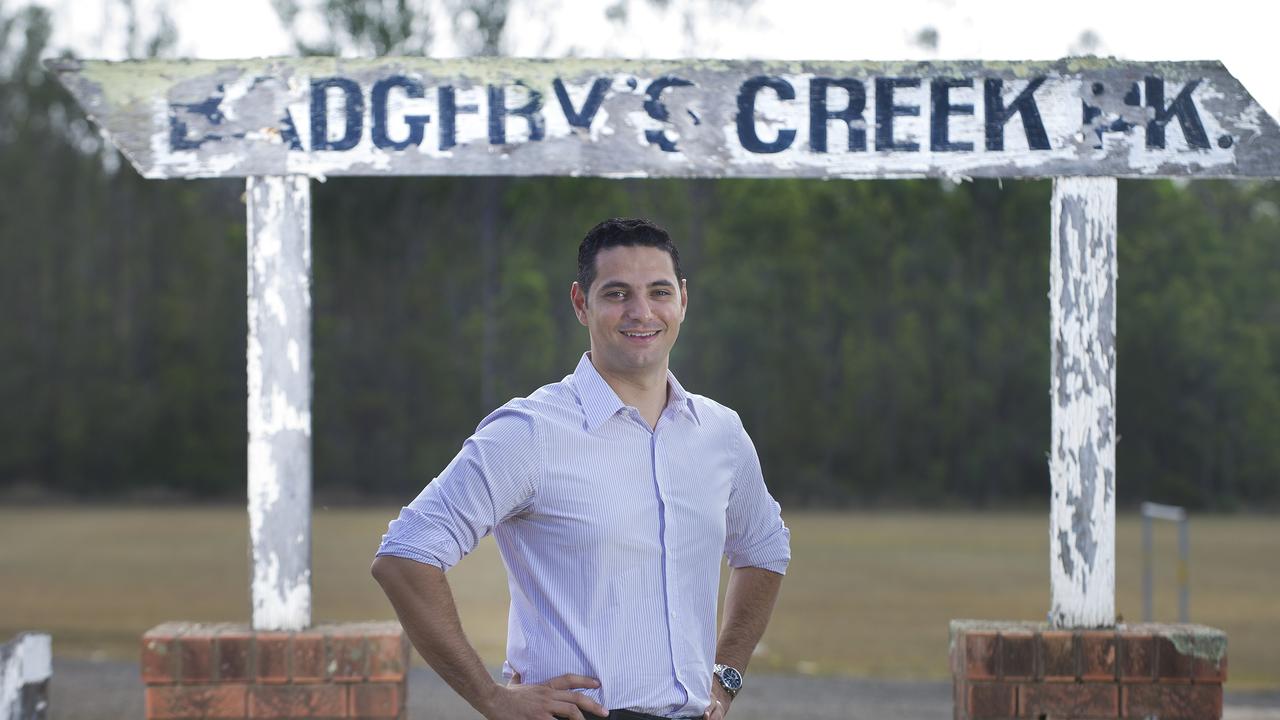 Liverpool City Mayor Ned Mannoun beside a Badgerys Creek sign adjacent to Badgerys Creek Park, ten years ago.