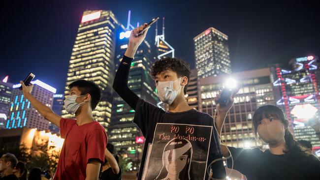 Secondary school students wave their phones in the air during an anti- government student rally in 2019. Picture: Getty Images