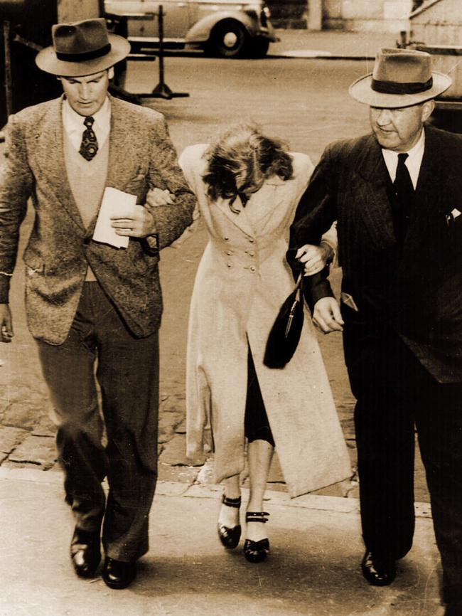 Jean Lee is escorted to the watch-house by detectives in 1949.