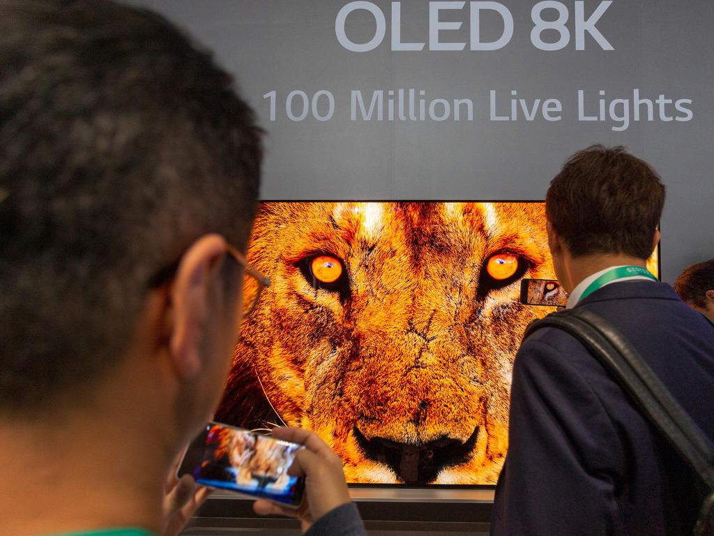 People look at OLED 8K television screens at the TCL exhibit on opening day of the 2020 Consumer Electronics Show (CES) in Las Vegas. Picture: David McNew