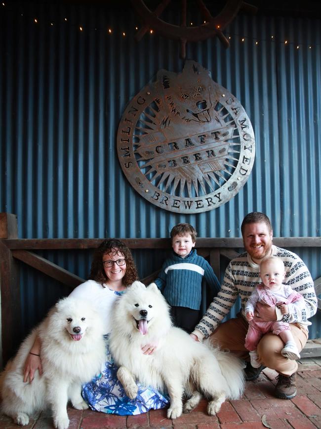 The Smiling Samoyed family, from left Hoppy, Kate, Kent, Alvin, Simon and Harriett Henning in front of the Smiling Samoyed Brewery sign in Myponga. Photo: Julia Henning