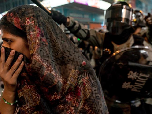 An ethnic minority woman is motioned away by riot police in Mongkok district in Hong Kong, China. Picture: Getty Images