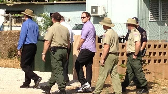 Zak Grieve is escorted around locations in Katherine as part of the Ray Niceforo murder trial. Picture: Meagan Dillon