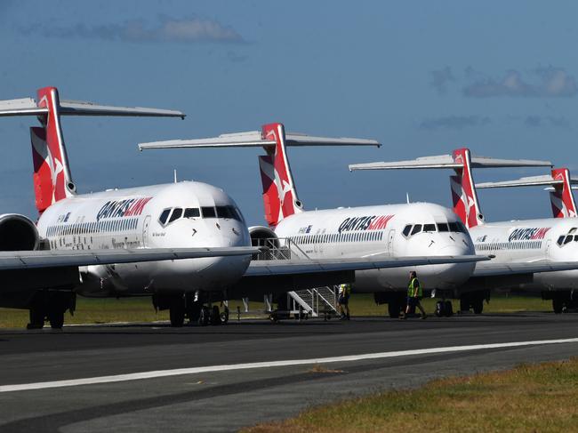 Grounded Qantas aircraft are seen parked at Brisbane Airport in Brisbane, Tuesday, April 7, 2020. Brisbane Airport Corporation (BAC) is working with airlines by accommodating up to 100 grounded aircraft free of charge in response to government-mandated travel restrictions that have grounded a significant proportion of Australia's airline fleet because of the Coronavirus (COVID-19). (AAP Image/Darren England) NO ARCHIVING