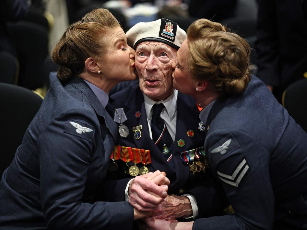 D-Day veteran Alec Penstone is kissed by members of the D-Day Darlings at a London event launching the 80th anniversary of the 1944 Allied landings in France. Picture: Henry Nicholls/AFP