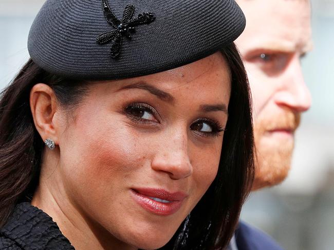 (FILES) In this file photo taken on April 25, 2018 Britain's Prince Harry (R) and his US fiancee Meghan Markle arrive to attend a service of commemoration and thanksgiving to mark Anzac Day in Westminster Abbey in London on April 25, 2018. - Meghan Markle has revealed she suffered a miscarriage in July this year, writing in the New York Times on November 25, 2020 of the deep grief and loss she endured with her husband Prince Harry. (Photo by Adrian DENNIS / AFP)