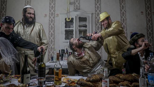 Ultra orthodox Jewish men from Jerusalem’s Mea Shearim neighbourhood drink wine and celebrate the Jewish holiday of Purim. The men’s poses, along with the lights and colours of the picture, are reminiscent of Ancient Roman banquets. Picture: Haim Goldberg