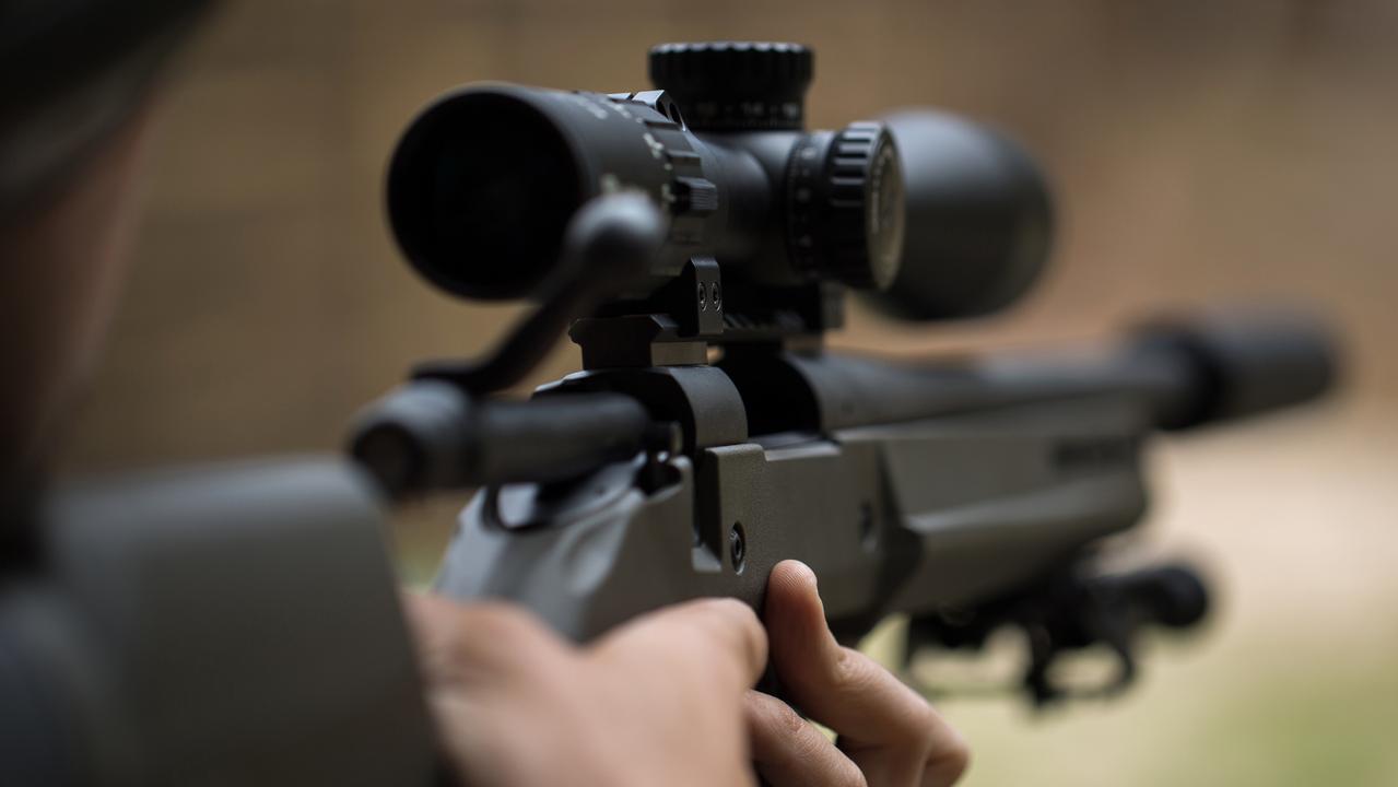 Sniper shooting rifle by looking through a scope. Picture: iStock/Artem Zakharov