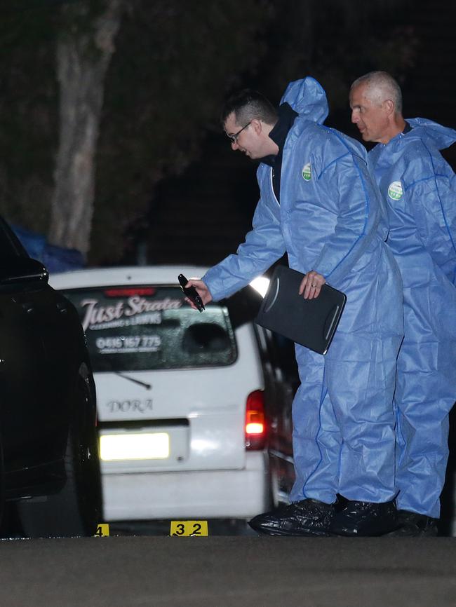 Forensic officers examine the scene. Pictures: Bill Hearne