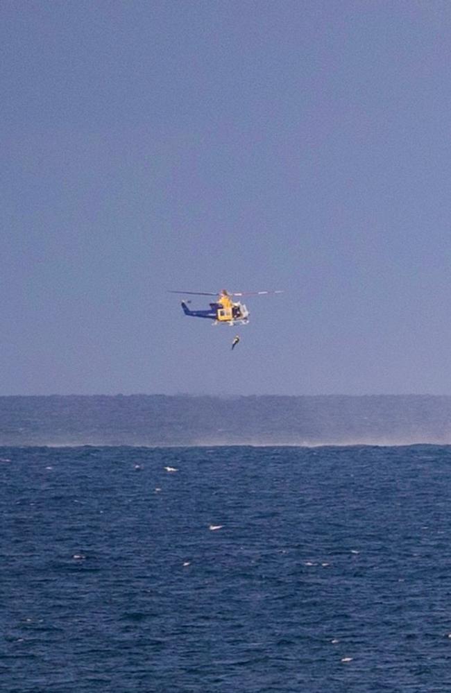 The dramatic rescue as seen from Dolphin Heads. Ryan Taylor, 33, and brothers Sean and Mitch Cook had spent Friday fishing near an island off Mackay'&#128;&#153;s coast and were returning with a hefty haul in the Esky when their boat experienced '&#128;&#156;fuel drama'&#128;&#157;. Picture: Louise Smith